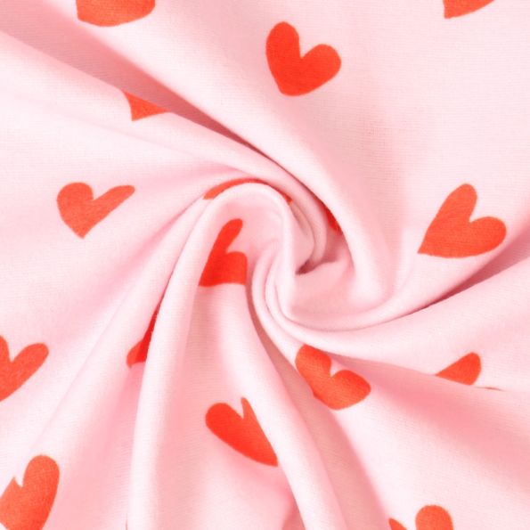 Tissu Flanelle de Coton  Caline cœurs Rouges sur fond Rose - Par 10 cm