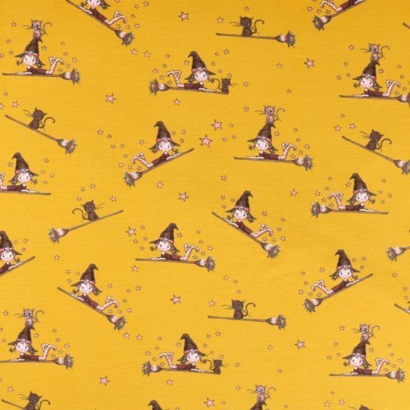 Tissu jersey molletonné Sorcière sur son balais sur fond Jaune moutarde - Par 10 cm