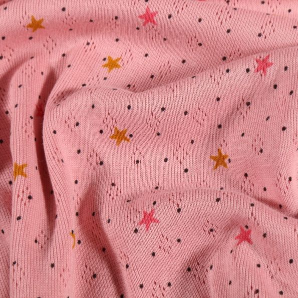 Tissu Jersey ajouré Petites étoiles moutarde et rose sur fond Rose - Par 10 cm