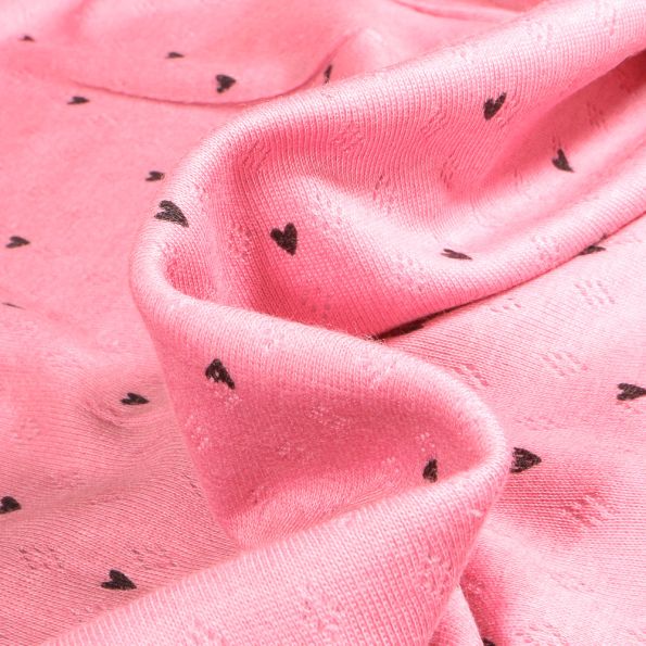 Tissu jersey ajouré Heart sur fond Rose - Par 10 cm