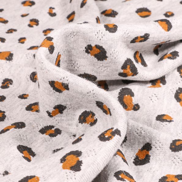 Tissu jersey ajouré LéoLéo sur fond Gris clair - Par 10 cm