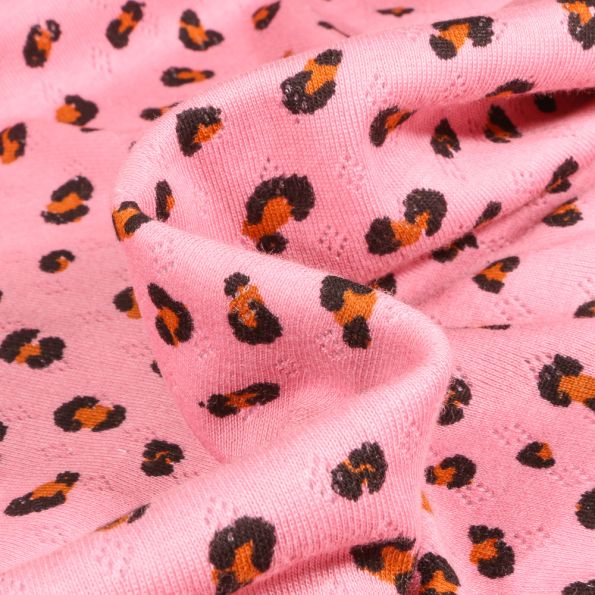 Tissu jersey ajouré LéoLéo sur fond Rose - Par 10 cm