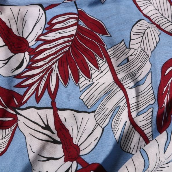 Tissu Viscose Grandes feuilles de palmier sur fond Bleu - Par 10 cm