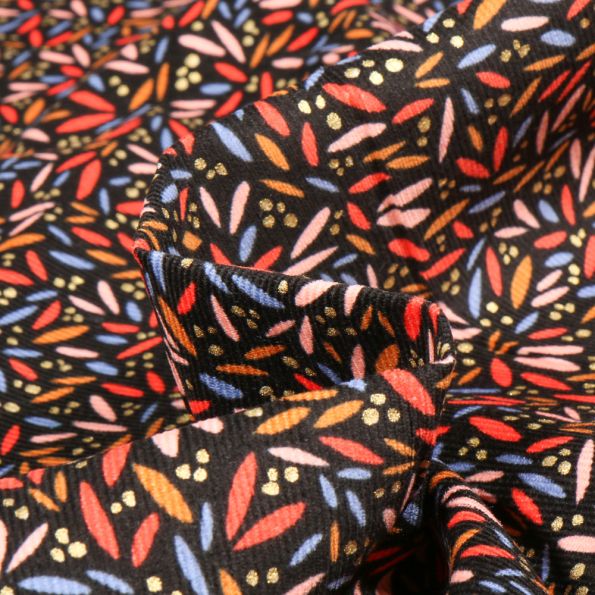 Tissu Velours milleraies Pétales Colorées sur fond Noir - Par 10 cm