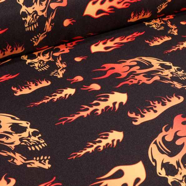 Tissu Burlington Têtes de mort flammes sur fond Noir - Par 10 cm