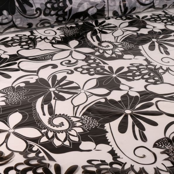 Tissu Imperméable Fleurs noires sur fond Transparent - Par 10 cm