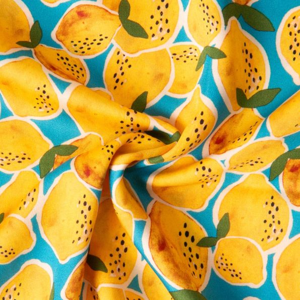 Tissu Viscose imprimé Limoncello pluie de citron sur fond Bleu turquoise - Par 10 cm