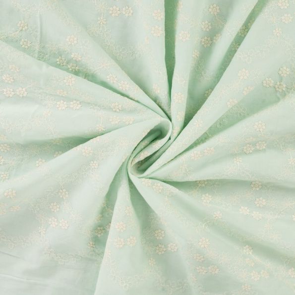 Tissu Voile de coton brodé Fleurs délicates sur fond Vert pastel - Par 10 cm