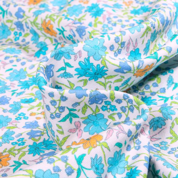 Tissu Jersey Coton Sweet Flower Florentine bleu clair sur fond Blanc - Par 10 cm