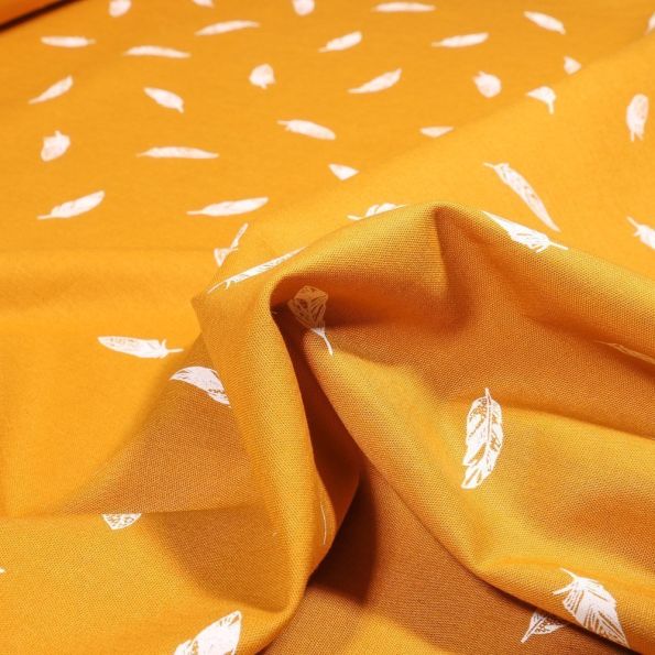 Tissu Coton imprimé Petites plumes sur fond Ocre - Par 10 cm