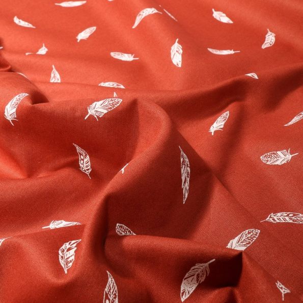 Tissu Coton imprimé Petites plumes sur fond Brique - Par 10 cm