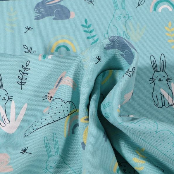 Tissu Jersey Coton Lapins en balade sur fond Bleu - Par 10 cm
