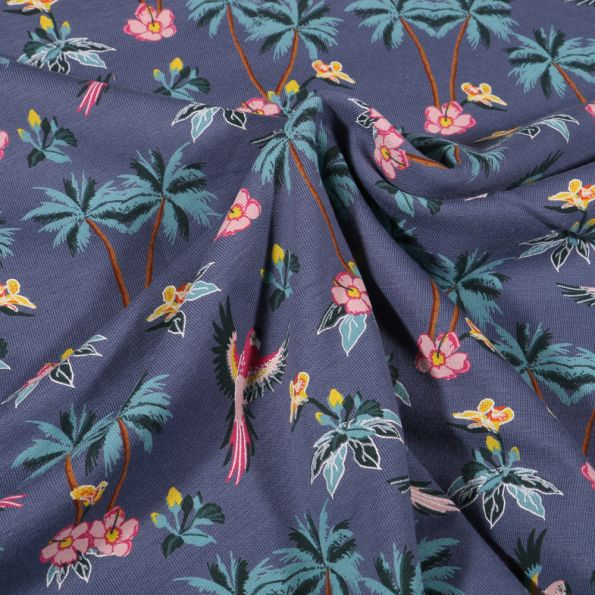 Tissu Jersey Coton Palmiers fleurs d'hibiscus et perroquet sur fond Bleu denim - Par 10 cm