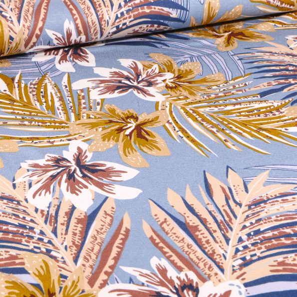 Tissu Jersey Viscose Feuilles tropicales colorées sur fond Bleu lavande - Par 10 cm
