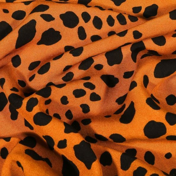 Tissu Viscose Tâches noires sur fond Orange - Par 10 cm