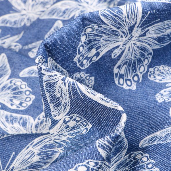 Tissu Jean Denim Papillons blancs sur fond Bleu - Par 10 cm