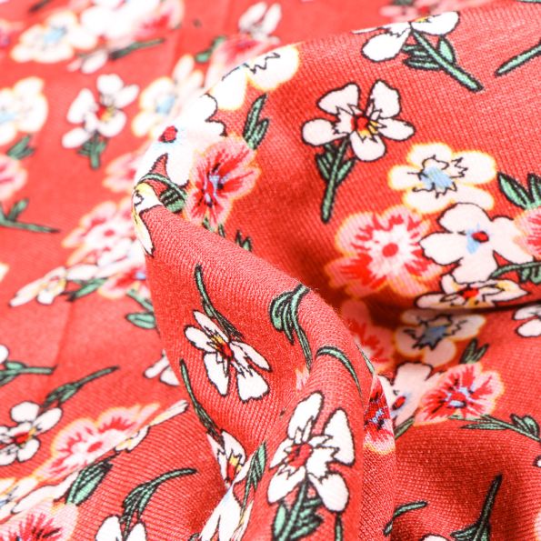 Tissu Jersey Viscose  Bouquets de fleurs colorés sur fond Corail - Par 10 cm