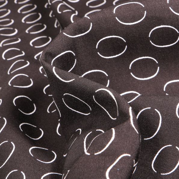 Tissu Viscose Popeline Anneaux sur fond Noir - Par 10 cm