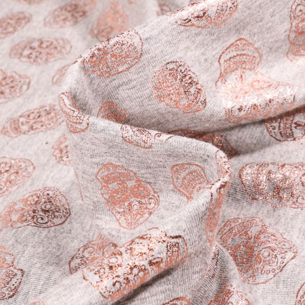 Tissu Jersey Coton Têtes de morts métallisées sur fond Gris chiné - Par 10 cm