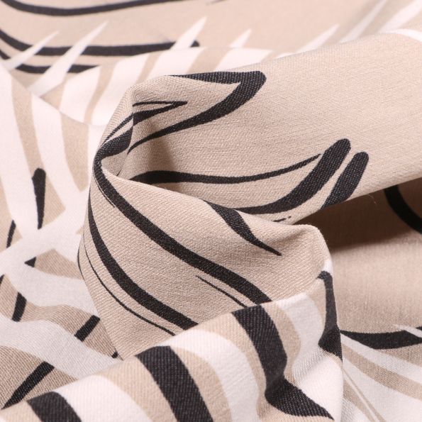 Tissu Bengaline Feuilles noires et blanches sur fond Beige - Par 10 cm