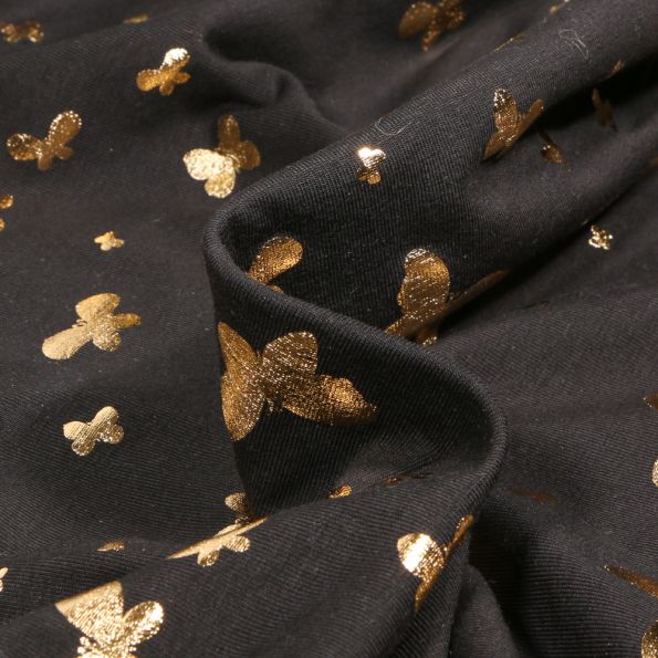 Tissu Jersey Coton Papillons métalissés sur fond Noir - Par 10 cm