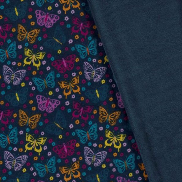 Tissu Sweat envers minky Papillon El sur fond Bleu marine - Par 10 cm