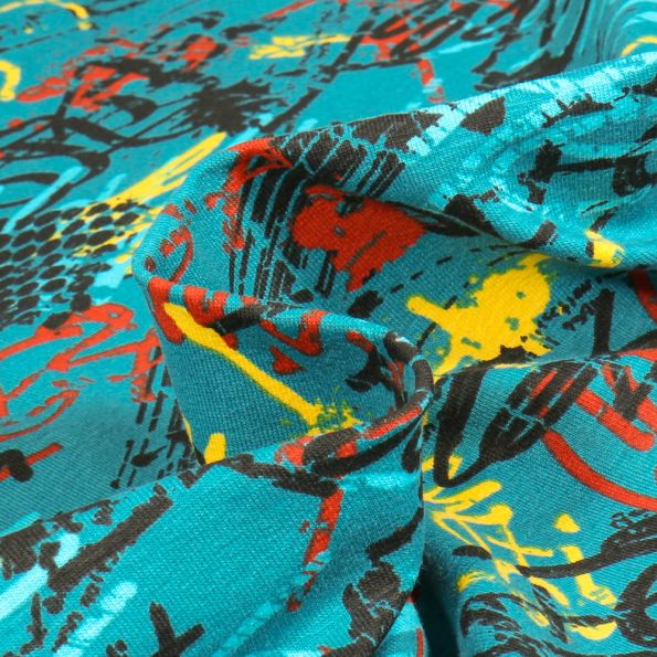 Tissu Jersey Coton Graff peinture sur fond Bleu turquoise - Par 10 cm