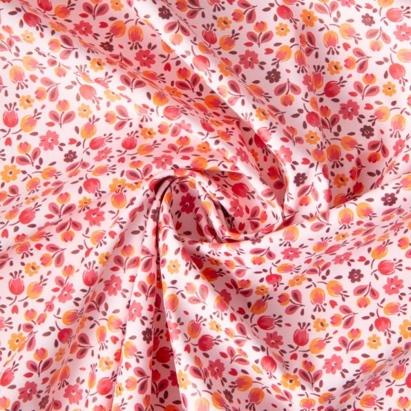 Tissu Imperméable imprimé Fleuris Caseille sur fond Rose clair - Par 10 cm