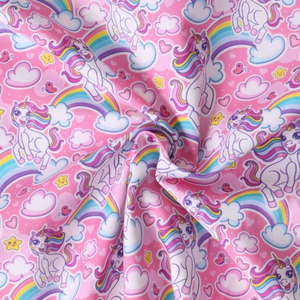 Tissu Coton imprimé  Ella licornes et arc en ciel sur fond Rose bonbon - Par 10 cm