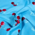 Tissu Jersey Coton Cerises métallisées sur fond Bleu turquoise
