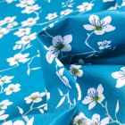 Tissu Coton enduit Fleur d'amandier sur fond Bleu