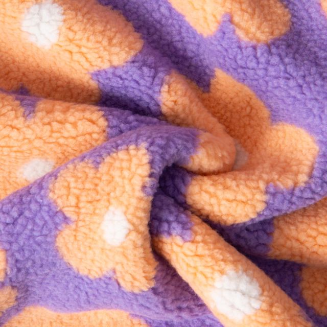 Tissu Sherpa Elya Fleurs Oranges sur fond Violet