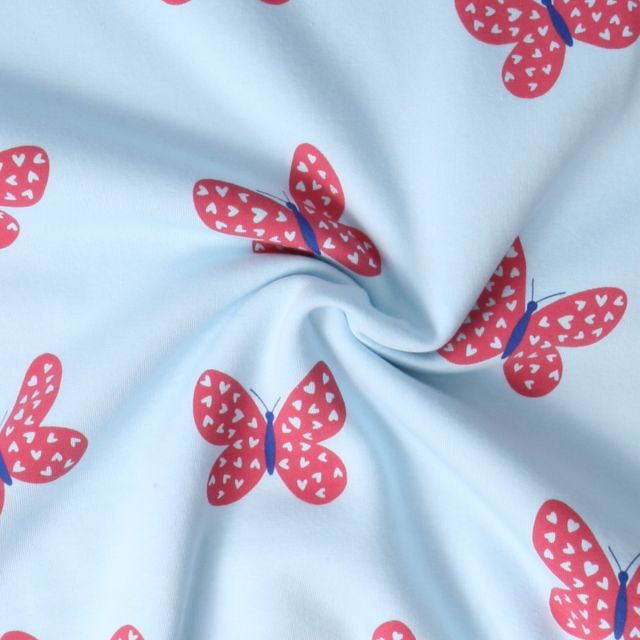 Tissu Sweat envers molletonné Lili papillons Rouges sur fond Bleu ciel