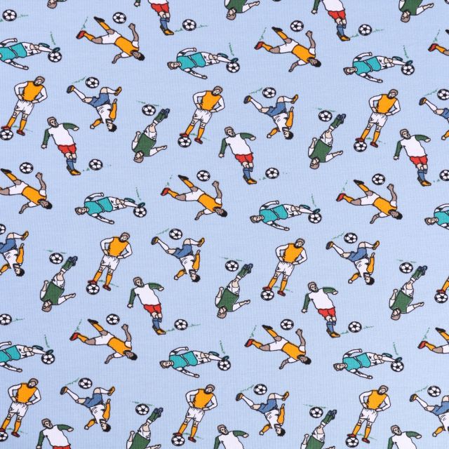 Tissu Jersey Coton Footballeurs Multicolores sur fond Bleu ciel - Par 10 cm