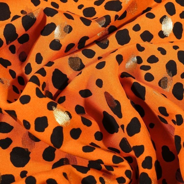Tissu Viscose Pois déstructurés noirs et dorés sur fond Orange - Par 10 cm