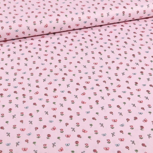 Tissu Coton imprimé Petits bouquets de fleurs et papillons sur fond Rose - Par 10 cm
