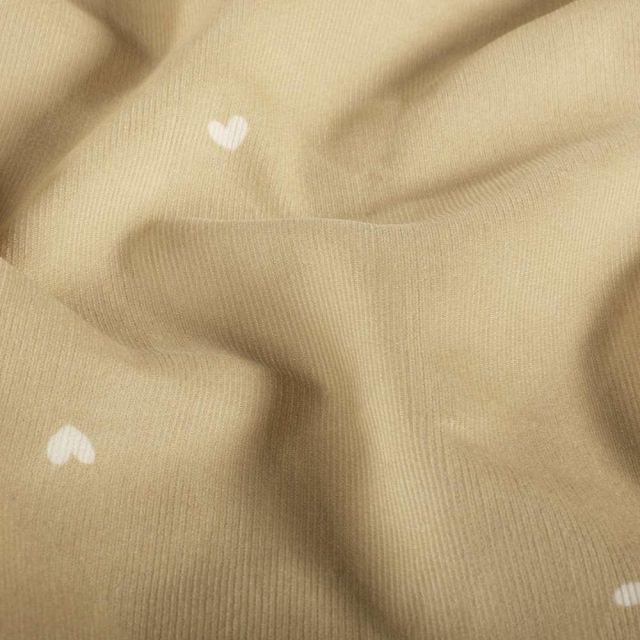 Tissu Velours milleraies Nahia cœurs Blancs sur fond Beige sable