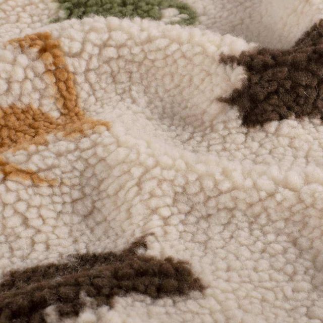 Tissu Fausse fourrure Mouton Nahla dinos Multicolores sur fond Beige clair