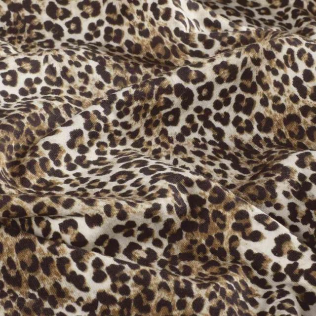 Tissu Sweat léger French Terry Alya extensible léopard Brun et Noir sur fond Beige sable