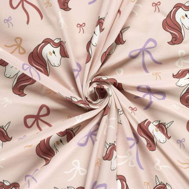 Tissu Jersey Coton imprimé Licorne et noeuds sur fond Rose bébé