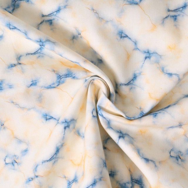 Tissu Coton imprimé  Auriane marbrures bleues sur fond Crème