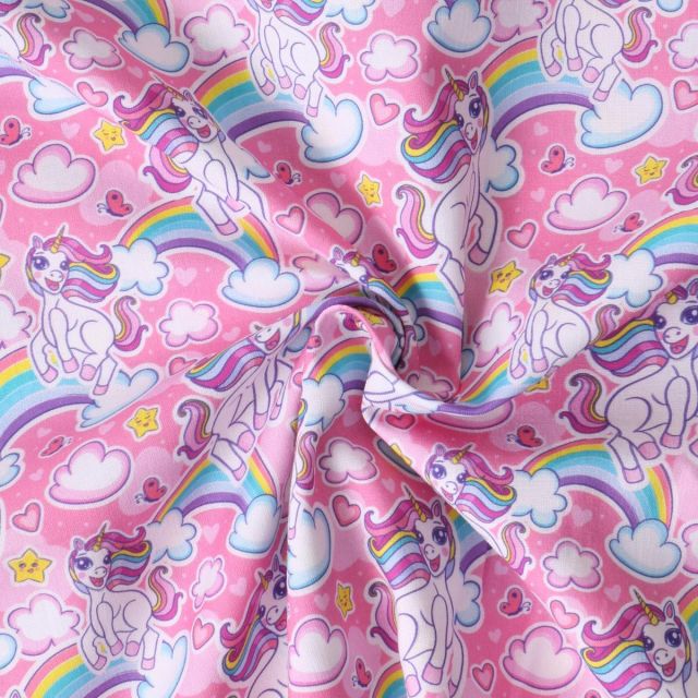 Tissu Coton imprimé  Ella licornes et arc en ciel sur fond Rose bonbon
