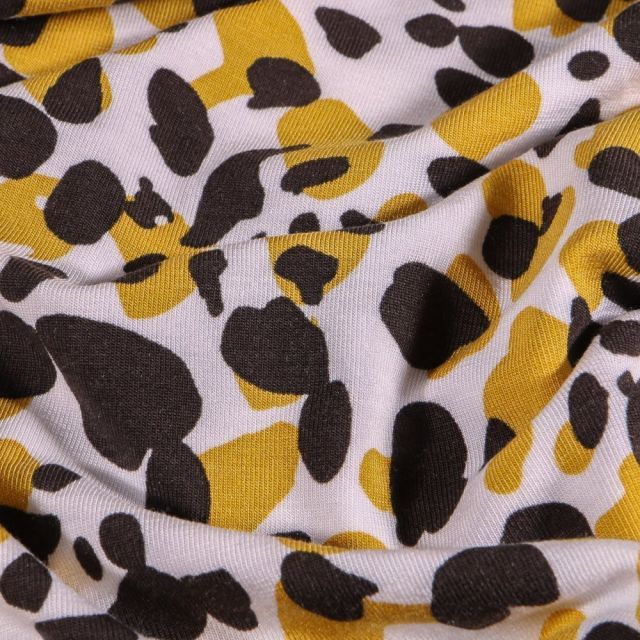 Tissu Jersey Modal Galets jaunes et noirs sur fond Blanc - Par 10 cm
