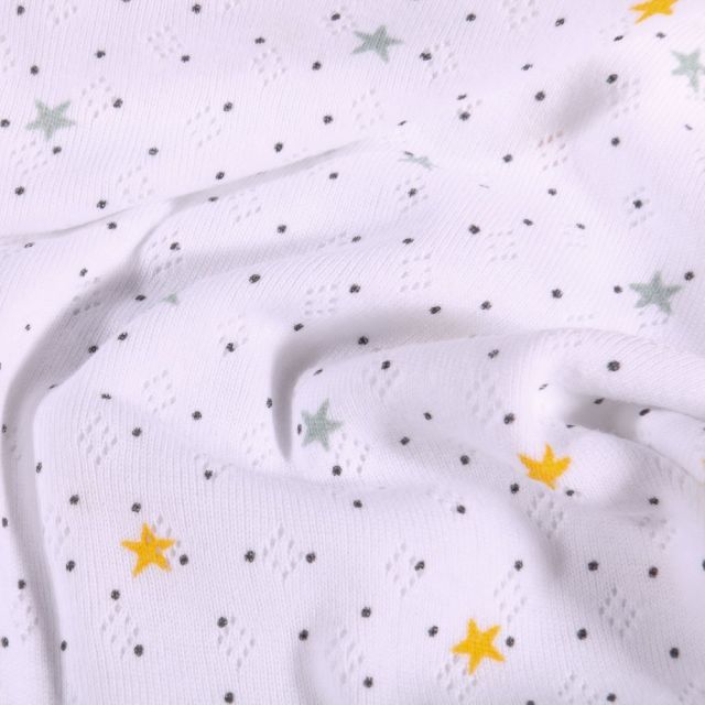 Tissu Jersey ajouré Petites étoiles grises et jaunes sur fond Blanc - Par 10 cm