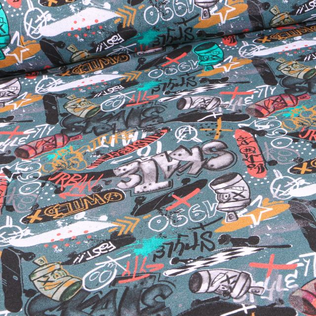 Tissu Jersey Coton envers gratté Street art sur fond Vert d'eau