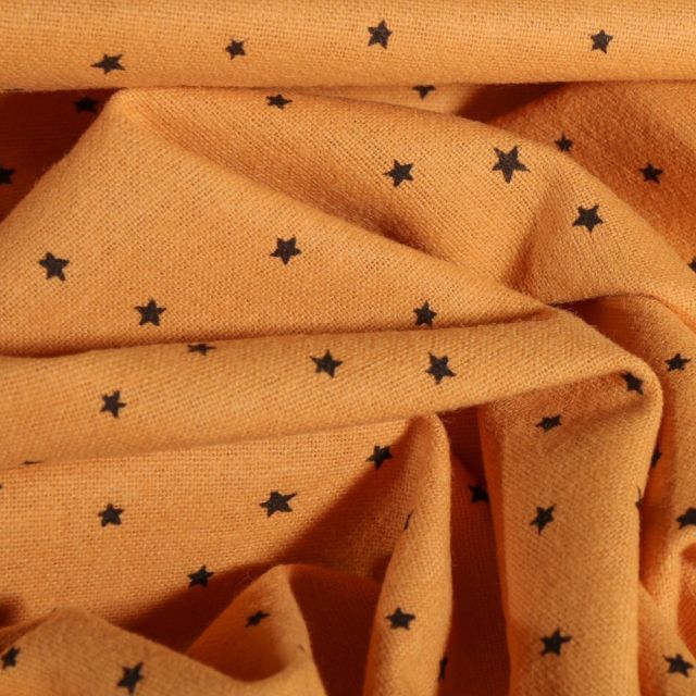 Tissu Flanelle de coton Petites étoiles noires sur fond Jaune moutarde - Par 10 cm