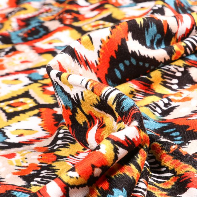 Tissu Jersey Viscose  Motifs ethniques colorés sur fond Orange