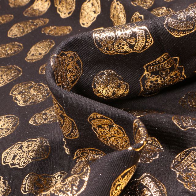 Tissu Jersey Coton Têtes de morts métallisées sur fond Noir