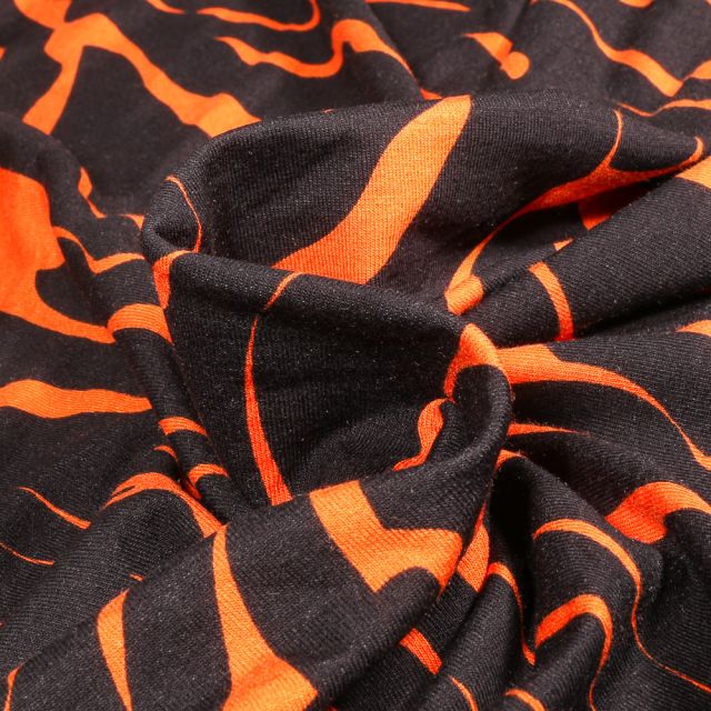Tissu Jersey Viscose  Zébré orange sur fond Noir