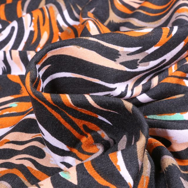 Tissu Jersey Viscose  Lignes abstraites colorées orange sur fond Noir